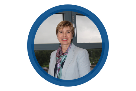 Pictured Beth Lawton - short blonde/ brown hair, wearing pearl earrings, blue/ purple street 'map' design silk scarf with navy top and powder blue dress jacket.